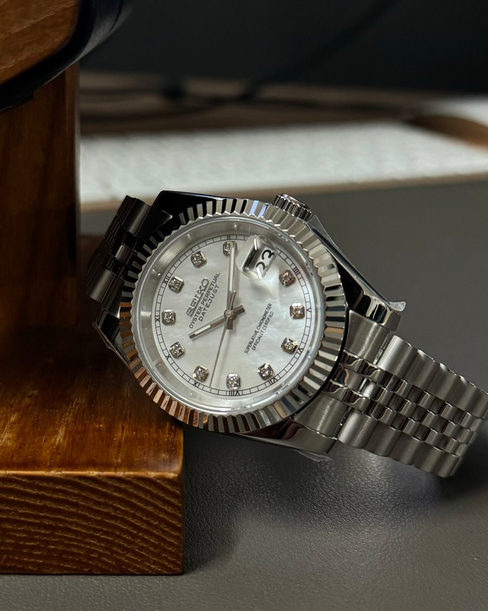 white diamond dial stainless steel Seiko NH35 mod watch on jubilee bracelet, angle view