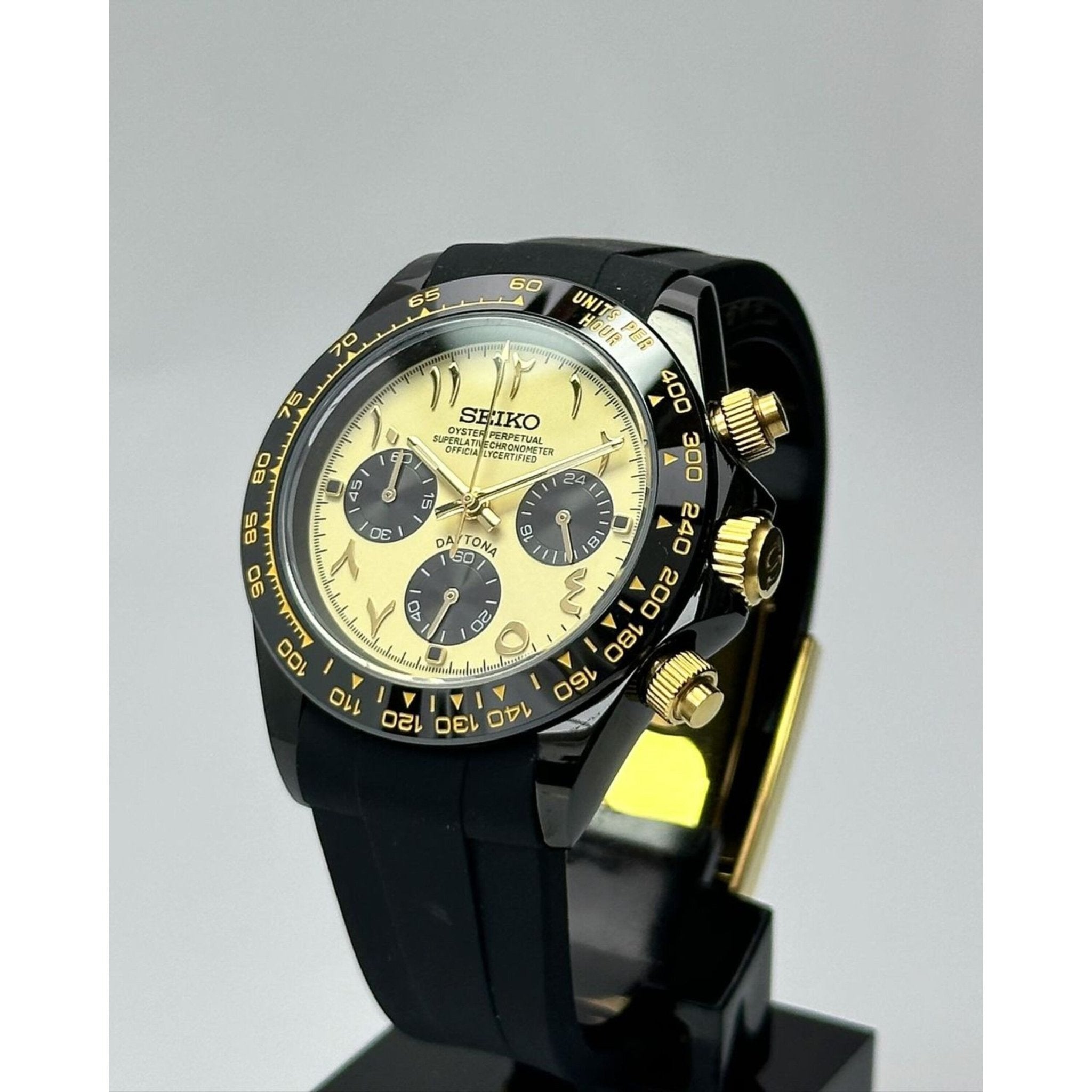 yellow Arabic dial Seiktona watch with black case and gold pushers close-up